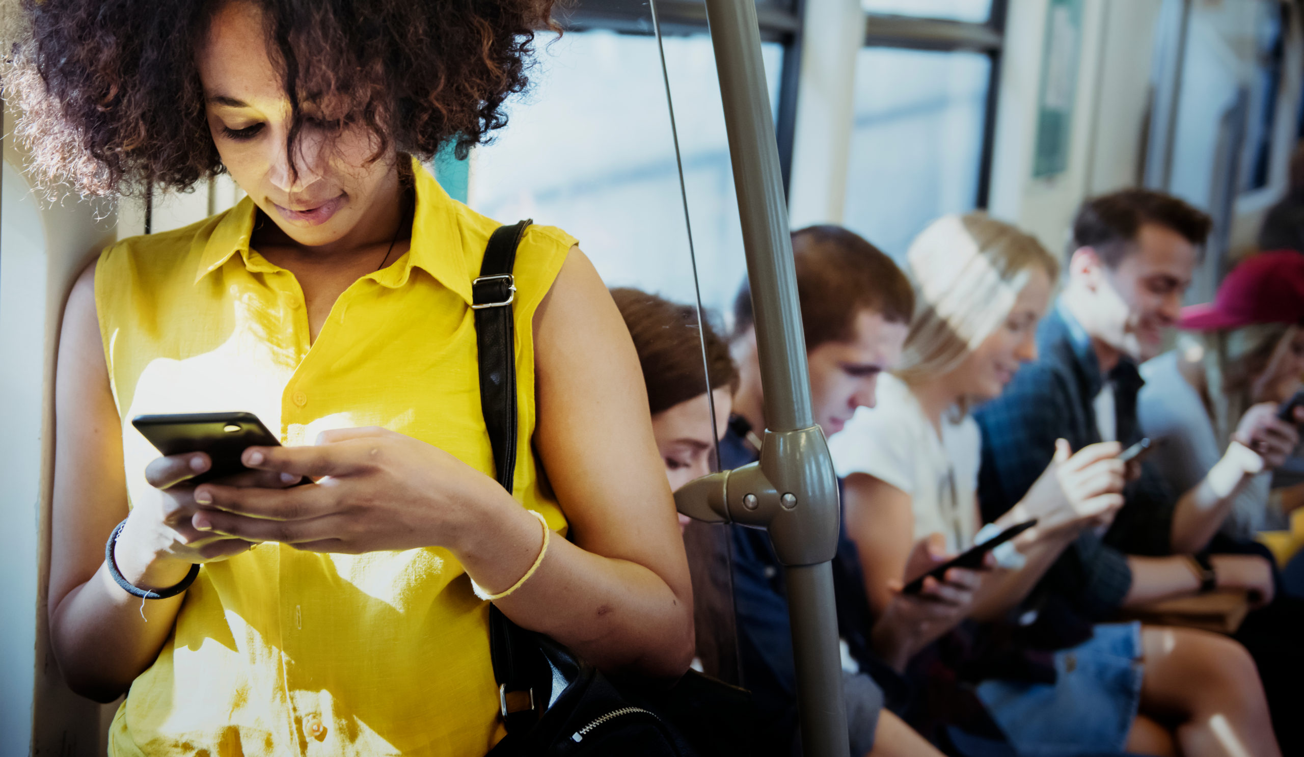 Young,Woman,Using,A,Smartphone,In,A,Subway